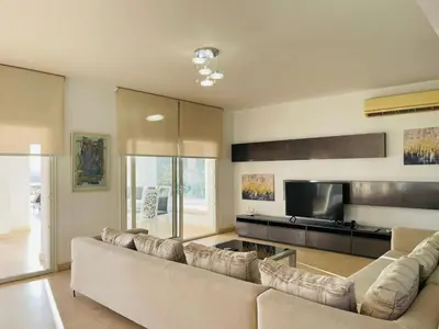 a living room with a large couch and a television at 5 bedroom villa with private pool at el gouna in Hurghada