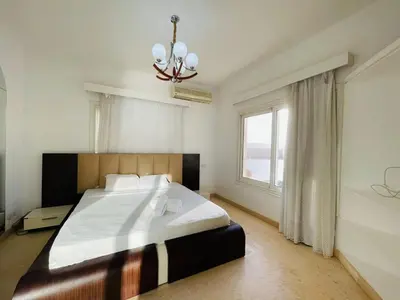 a bedroom with a large bed and a window at 5 bedroom villa with private pool at el gouna in Hurghada