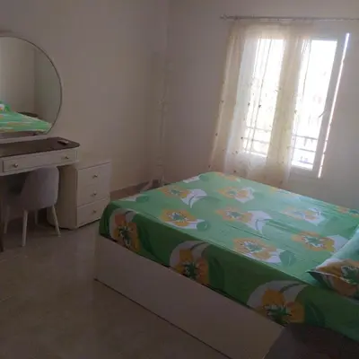a bedroom with a bed and a dresser and a mirror at Golden Tayeb Hurghada Compound in Hurghada