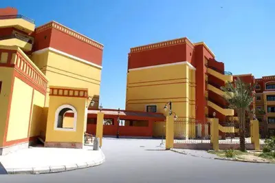 a group of buildings in a parking lot at Esplanadа Apartments in Hurghada