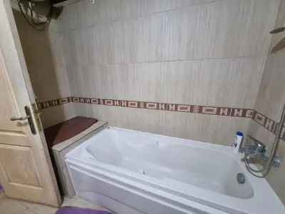 a bathroom with a white tub and a toilet at Esplanadа Apartments in Hurghada