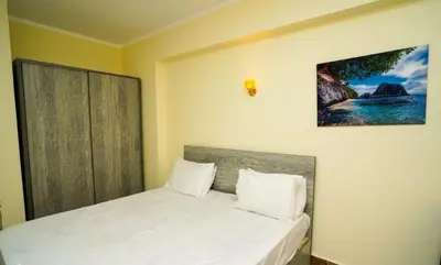 a bedroom with a bed with a picture on the wall at Florenze Khamsin Hurghada in Hurghada