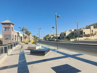 a row of benches on the side of a street at Florenze Khamsin Hurghada in Hurghada