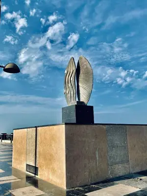 a statue in a parking lot with a blue sky at Florenze Khamsin Hurghada in Hurghada