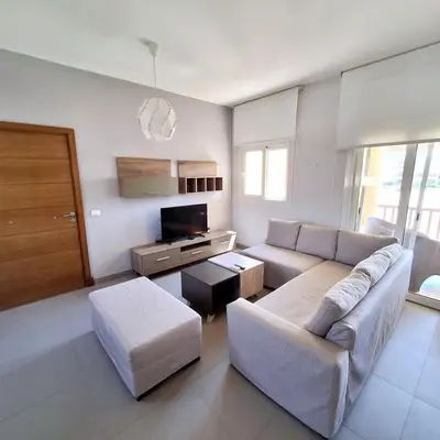 a living room with a couch and a tv at 2 Bedrooms First floor in Waterside Residence in Hurghada