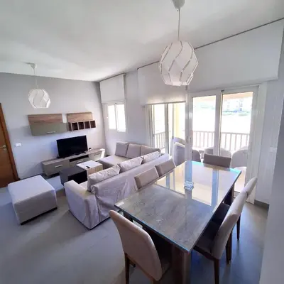a living room with a table and a couch at 2 Bedrooms First floor in Waterside Residence in Hurghada