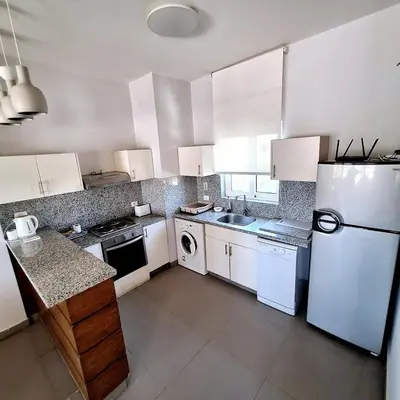 a kitchen with white appliances and a white refrigerator at 2 Bedrooms First floor in Waterside Residence in Hurghada
