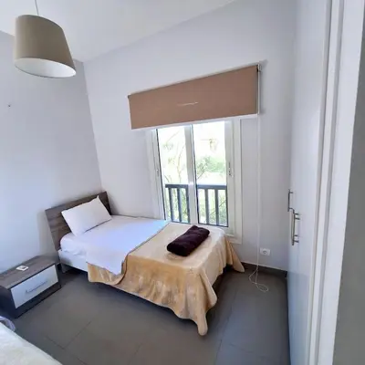a small bedroom with a bed and a window at 2 Bedrooms First floor in Waterside Residence in Hurghada