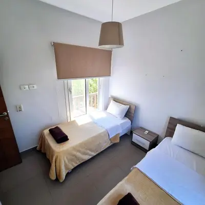a bedroom with two beds and a window at 2 Bedrooms First floor in Waterside Residence in Hurghada
