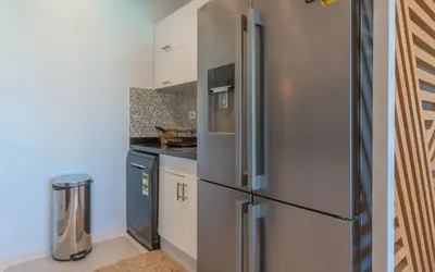 a kitchen with a stainless steel refrigerator at Relax in Style I Lagoon-Front 2BR in Swan Lake El Gouna in Hurghada