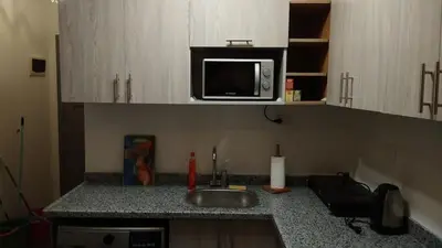 a kitchen counter with a sink and a microwave at Studiowohnung Aqua Infinity in Hurghada