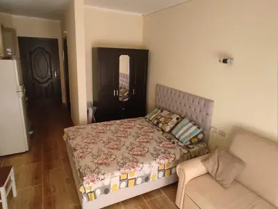 a bedroom with a bed and a couch at Florenza Khamsin Resort compound in Hurghada