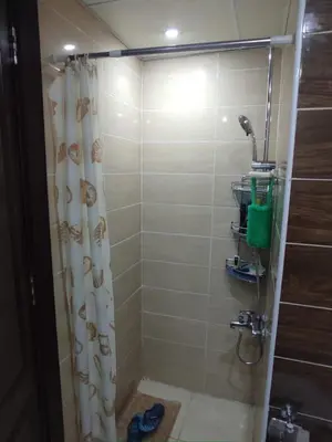 a bathroom with a shower with a shower curtain at Florenza Khamsin Resort compound in Hurghada