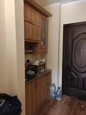 a kitchen with wooden cabinets and a counter top at Florenza Khamsin Resort compound in Hurghada