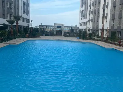 a large blue swimming pool in between two buildings at Hurghada Fanadir Bay in Hurghada