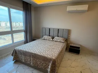 a bedroom with a bed and a large window at Hurghada Fanadir Bay in Hurghada