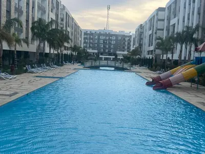 a large pool with a water slide in a city at Hurghada Fanadir Bay in Hurghada