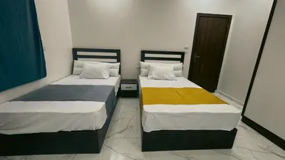 two beds sitting next to each other in a room at Prestige Residency in Hurghada