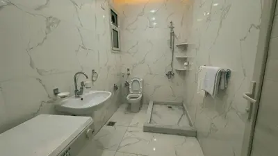 a white bathroom with a sink and a toilet at Prestige Residency in Hurghada