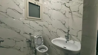 a bathroom with a sink and a toilet and a mirror at Prestige Residency in Hurghada