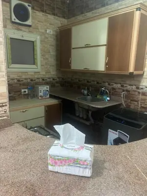 a kitchen with a sink and a counter with a counter at H&H Twin Apartment in Hurghada