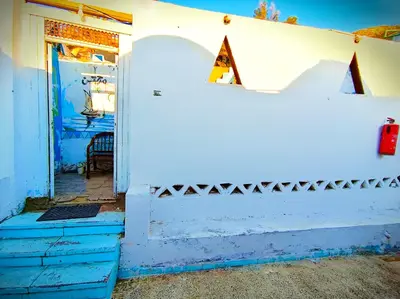 an open door to a white building with a white wall at Fox Nubian Hotel in Aswan