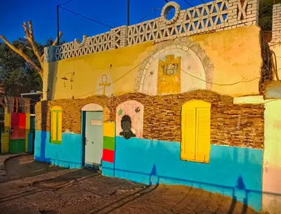 a building with colorful doors and windows on a street at Fox Nubian Hotel in Aswan