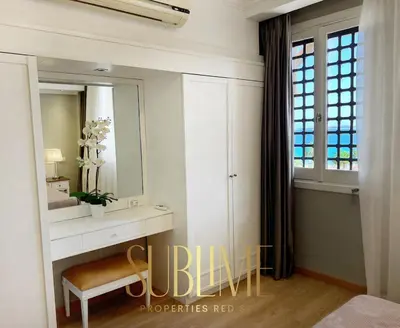 a bathroom with a vanity and a mirror and a chair at Tawaya 1br with sea view in Hurghada