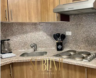 a kitchen counter with a sink and a stove at Tawaya 1br with sea view in Hurghada