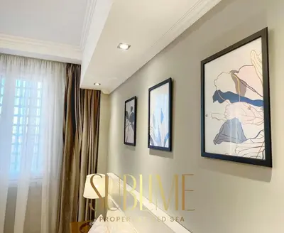 a room with three framed pictures on the wall at Tawaya 1br with sea view in Hurghada