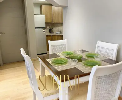 a dining room table with white chairs and a table and chairsktop at Tawaya 1br with sea view in Hurghada