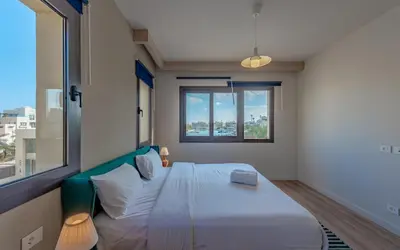 a bedroom with a large bed and a window at Relaxing 3BR Fanadir Marina Home l El Gouna Red Sea l Lagoon Views in Hurghada