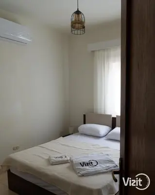 a bedroom with a bed with two towels on it at Stylish flat with terrace in Hurghada