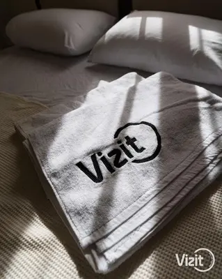 a towel with the word vitt on a bed at Stylish flat with terrace in Hurghada
