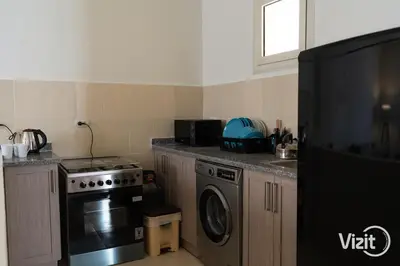 a kitchen with a stove and a dishwasher at Stylish flat with terrace in Hurghada
