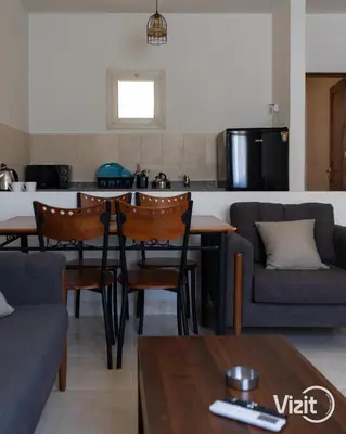 a kitchen and living room with a table and chairs at Stylish flat with terrace in Hurghada