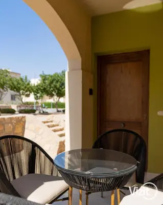 a glass table and chairs on a patio at Stylish flat with terrace in Hurghada