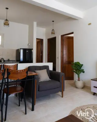 a living room with a couch and a table at Stylish flat with terrace in Hurghada