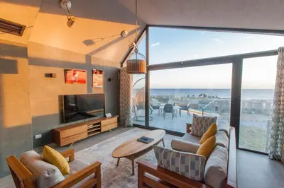 a living room with a couch and a large window at Stylish Seaview 2BR Soma bay Villa with Free Pool & Beach in Hurghada