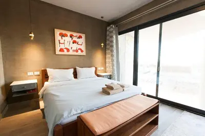 a bedroom with a large bed and a large window at Stylish Seaview 2BR Soma bay Villa with Free Pool & Beach in Hurghada