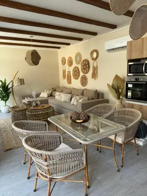a living room with a couch and a table and chairs at 2 BR with a small private pool in Hurghada