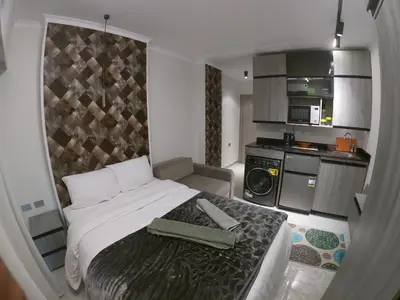 a small bedroom with a bed and a kitchen at Dive Hostel Hurghada Beach in Hurghada