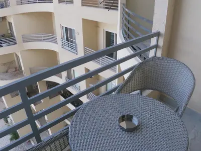a wicker chair sitting on the balcony of a building at Dive Hostel Hurghada Beach in Hurghada