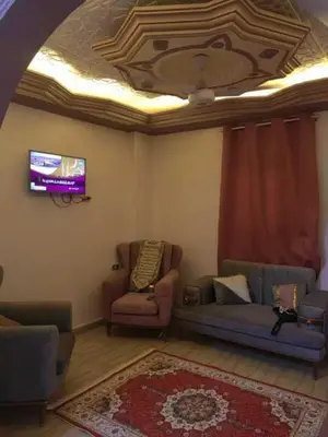a living room with two couches and a ceiling at شقة فاخرة خلف الاستاد اسوان in Aswan
