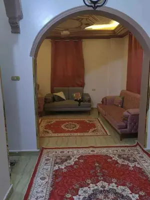 a living room with a couch and a couch and a table at شقة فاخرة خلف الاستاد اسوان in Aswan