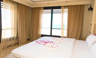 two cakes on a bed in a room with a window at Palmen Villa in Hurghada