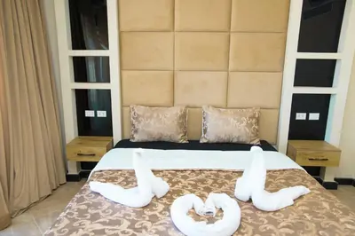 two white towels on a bed in a bedroom at Palmen Villa in Hurghada