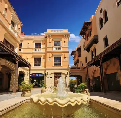 a fountain in a courtyard in front of a building at Palmen Villa in Hurghada