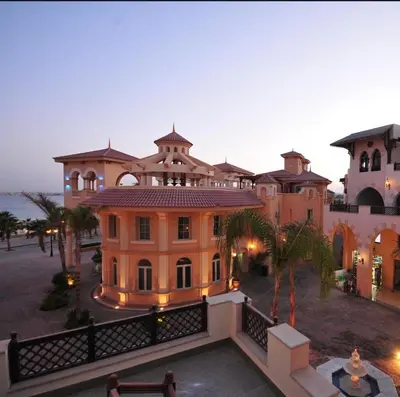 a large mansion with a fence in front of it at Palmen Villa in Hurghada