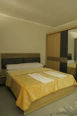 a bedroom with two beds and a mirror at Angeli Apartment Scandic Rezort in Hurghada